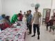 Brigadir Nofri, Bhabinkamtibmas Desa Teluk Kawal Distribusi Bantuan Pangan di Lingga Timur