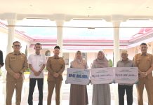 Bupati Aceh Jaya Serahkan Simbolis Santunan Klaim BPJS Ketenagakerjaan bagi Ahli Waris Aparatur Desa dan Pekerja Rentan