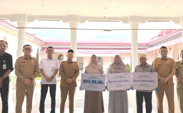 Bupati Aceh Jaya Serahkan Simbolis Santunan Klaim BPJS Ketenagakerjaan bagi Ahli Waris Aparatur Desa dan Pekerja Rentan